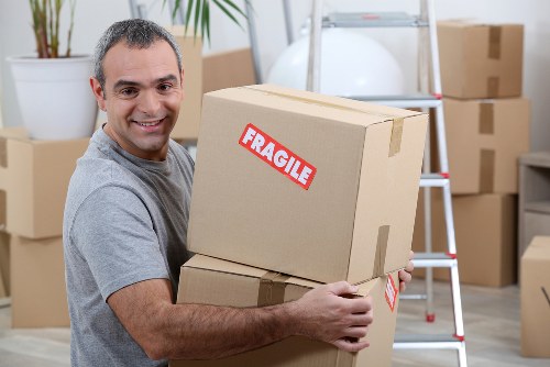 Removal team handling household furniture in a Marylebone street setting