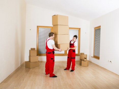 Furniture being carried through a Marylebone townhouse staircase during a house removal