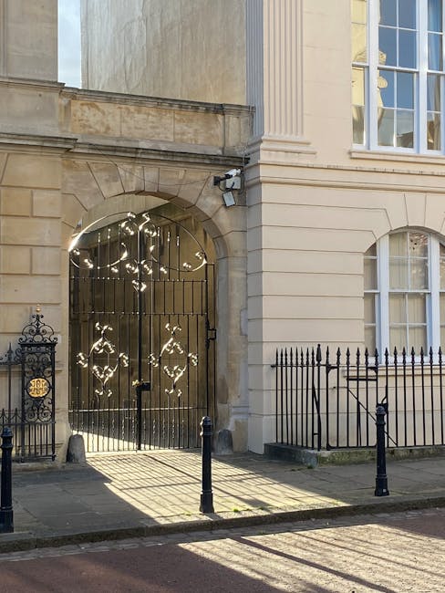 Photograph of a historic building at the corner of a street in Marylebone during daylight, featuring a rounded facade with signage for The Marylebone and No. 98. The building's exterior is painted in 